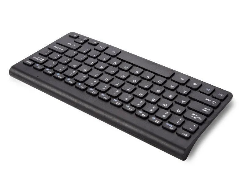 Black and white wireless keyboard and mouse set on a wooden desk.