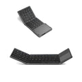 Black tri-fold portable Bluetooth keyboard shown open next to a smartphone, highlighting its slim profile.