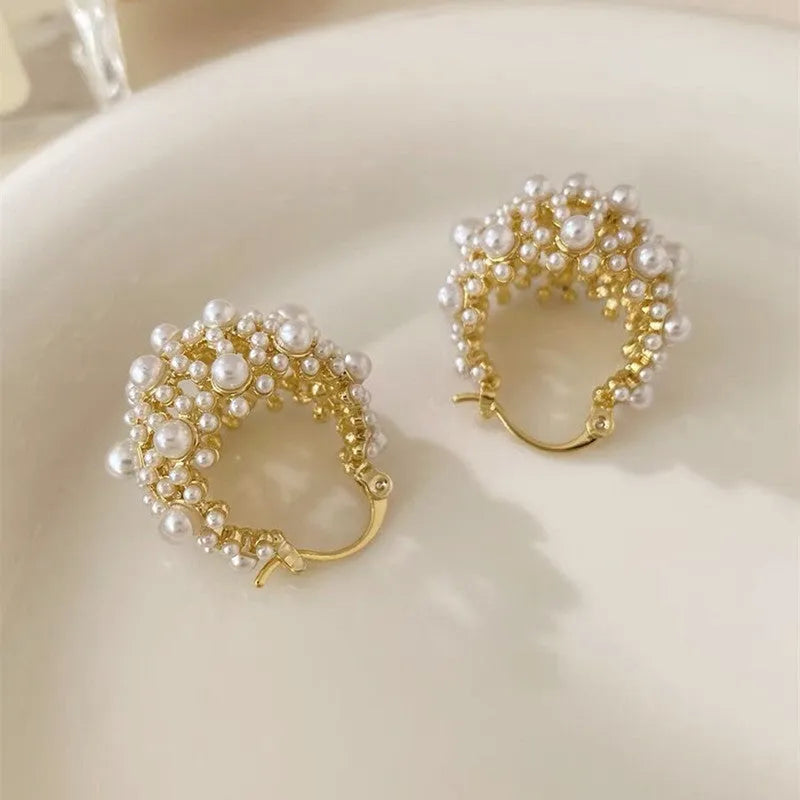 Women's gold copper earrings with floral basket design featuring small beads and pearl inlay detailing
