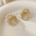 Women's gold copper earrings with floral basket design featuring small beads and pearl inlay detailing