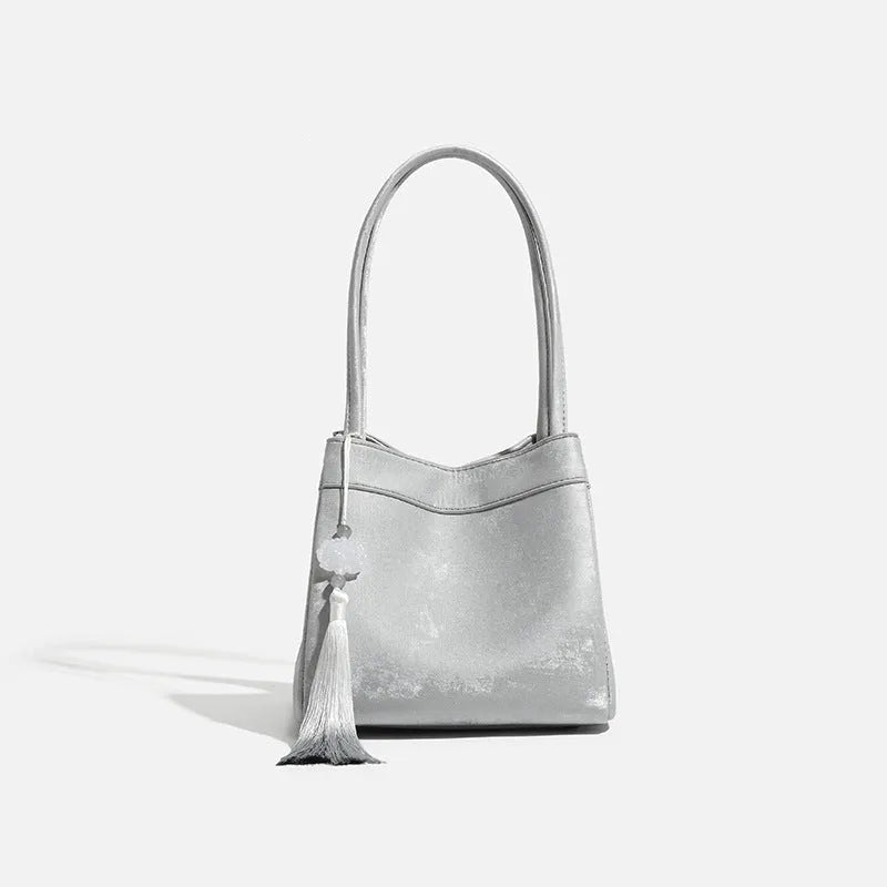 PU leather shoulder crossbody bag with single strap, tassel, open pocket, and sewing thread detail