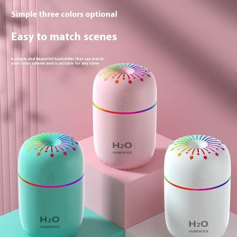 White USB mini humidifier with 300ml water tank on wooden desk next to laptop
