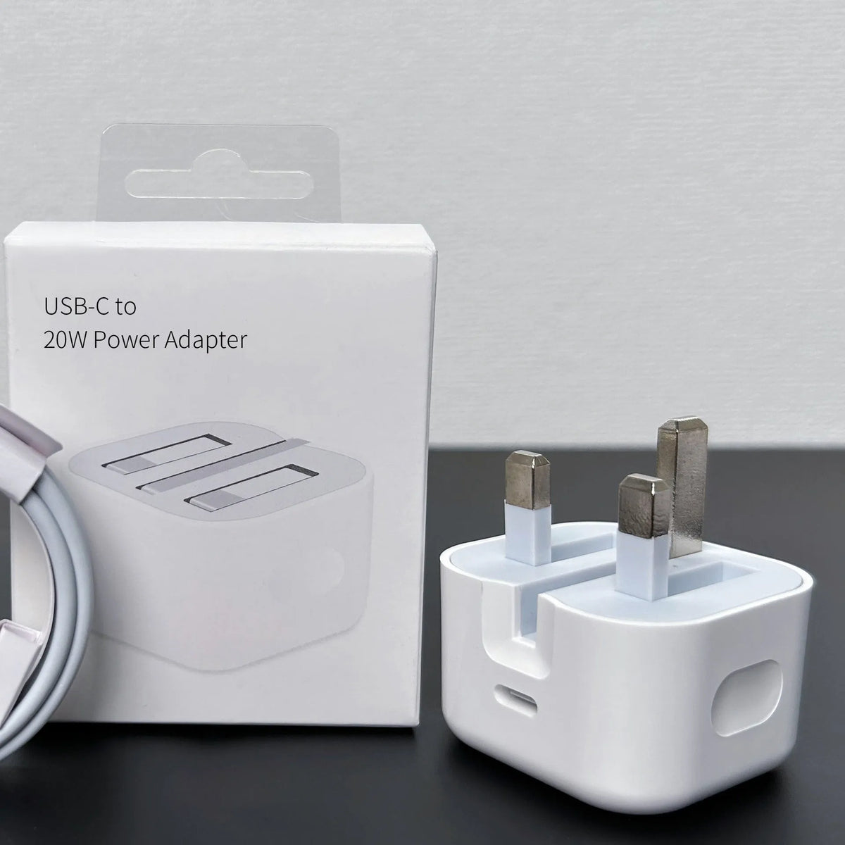White 20W USB-C PD wall charger with UK three-pin plug.