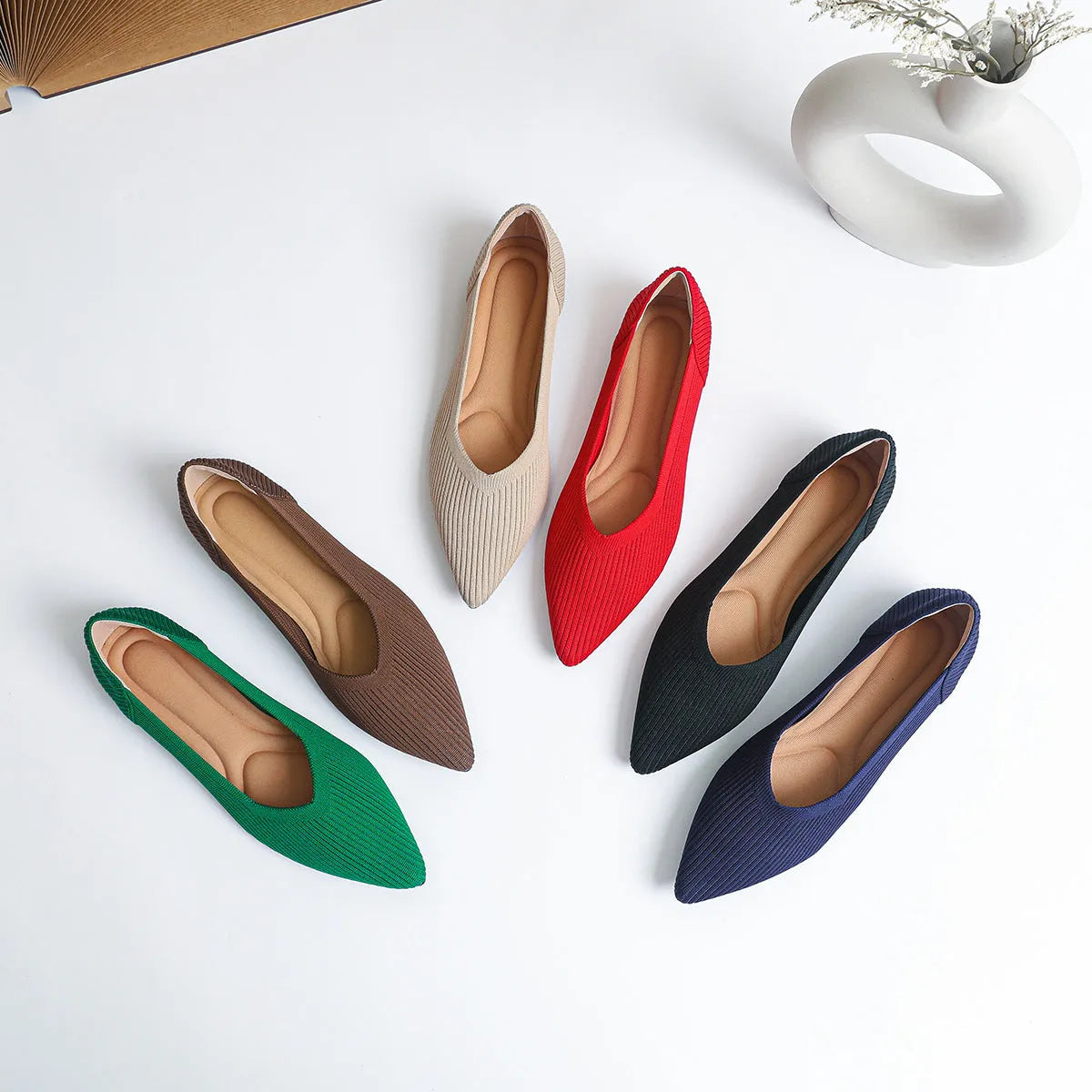 Women's apricot knit flat pump with pointed toe and rubber sole on a white background.