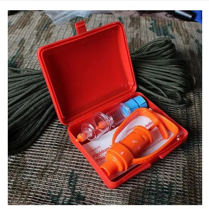 Orange portable first aid kit open to show vacuum suction pump, two suction cups, and medical accessories.
