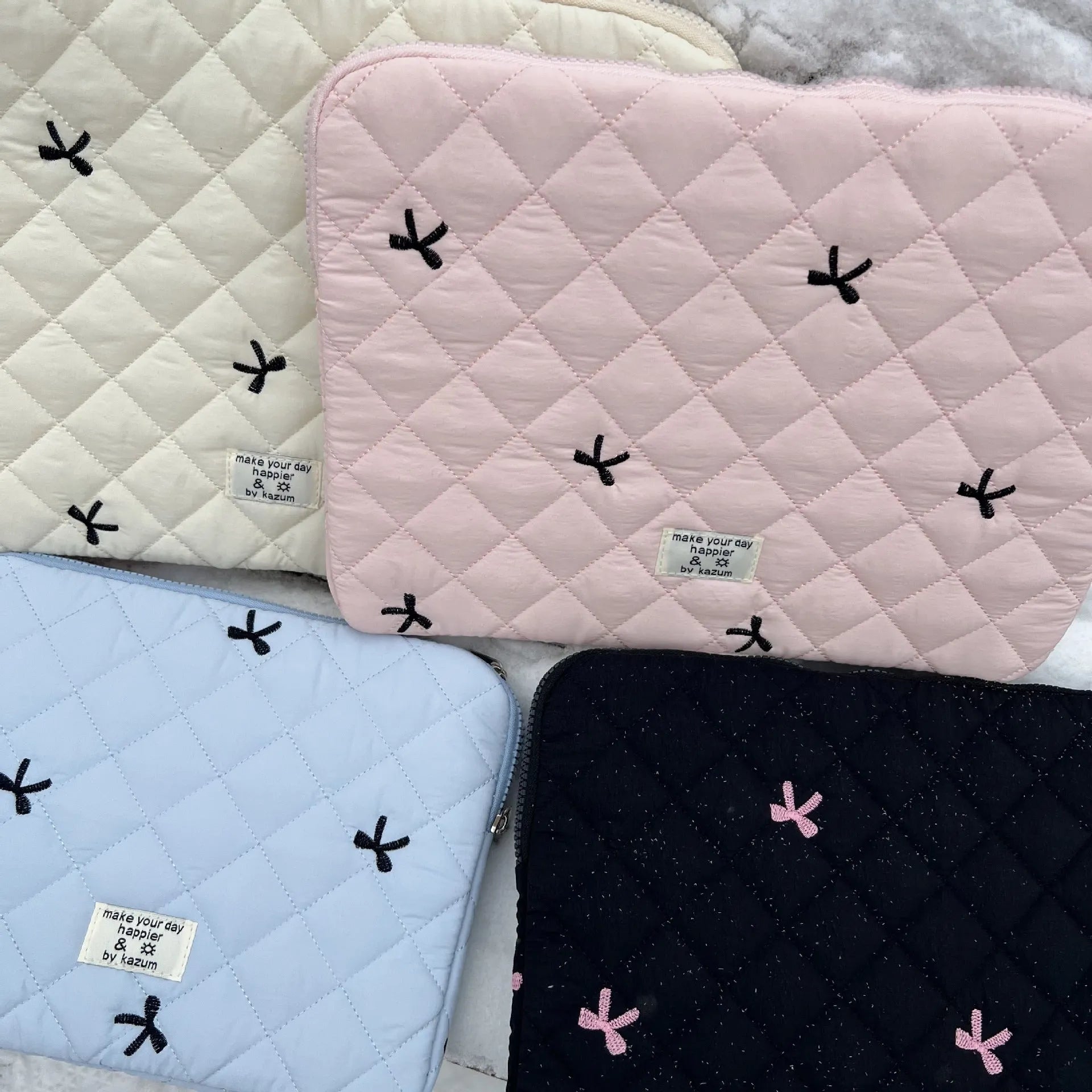 Embroidered rhombus bow detail on nylon laptop storage bag in light blue colour