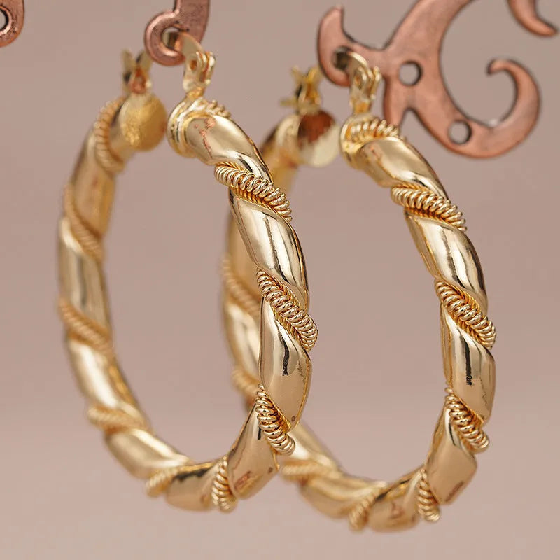 Golden geometric clip-on earrings with ring and line design elements