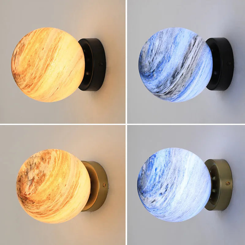 Planet Aisle bedside lamp with painted glass shade in black blue planet colour, on a table