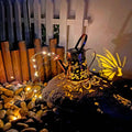 Tapered butterfly pattern solar garden lamp in warm white iron for outdoor decoration.