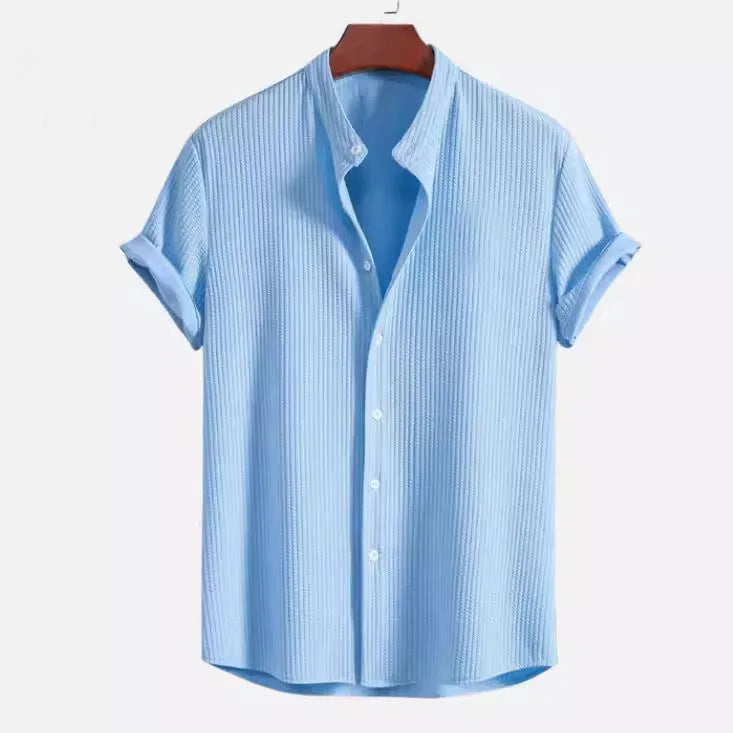 Men's loose fit short sleeve casual shirt in light blue, hanging on a plain background.