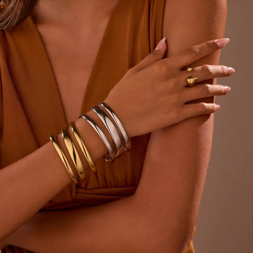 Women's stainless steel simple opening bracelet with geometric line design in gold or steel colour.