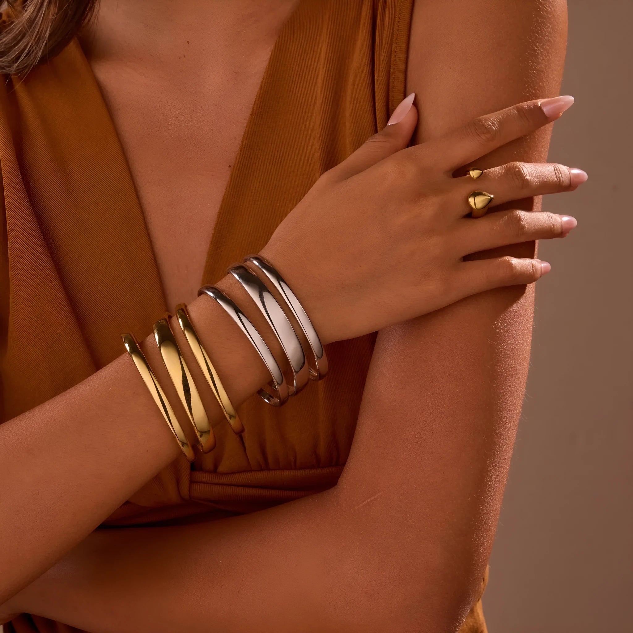 Women's stainless steel simple opening bracelet with geometric line design in gold or steel colour.