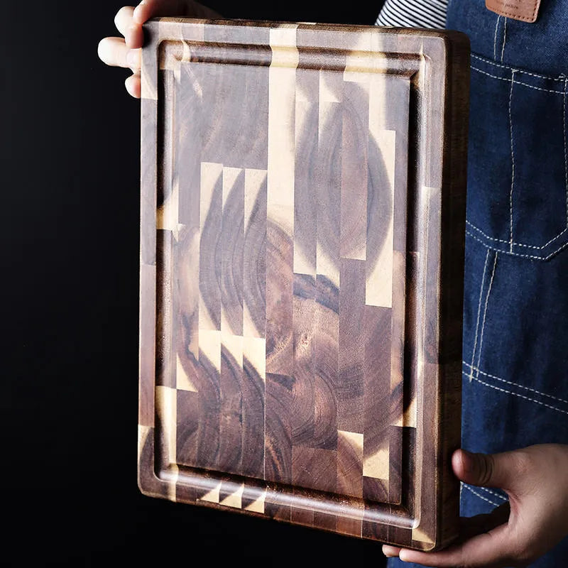 Brown parquet pattern solid acacia wood chopping board on a kitchen counter.