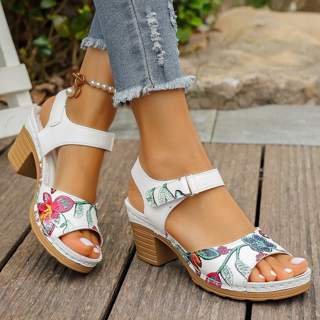White women's high heel sandals with velcro buckle closure showing PU leather upper and rubber sole
