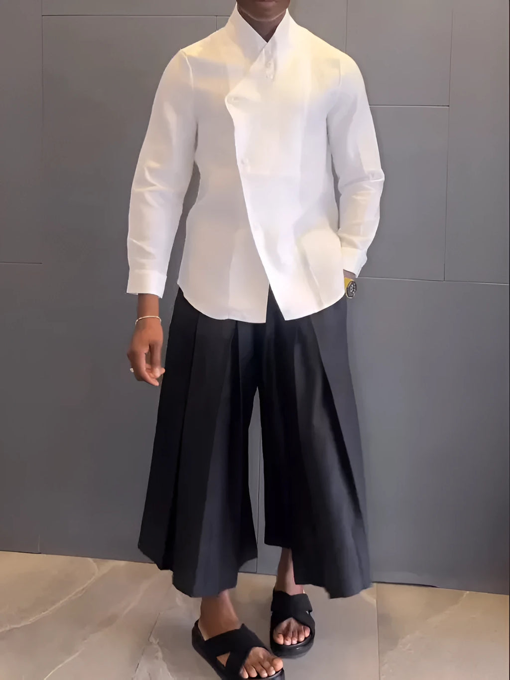 White asymmetric front long sleeve shirt paired with black pleated pants in a women's casual co-ord set.