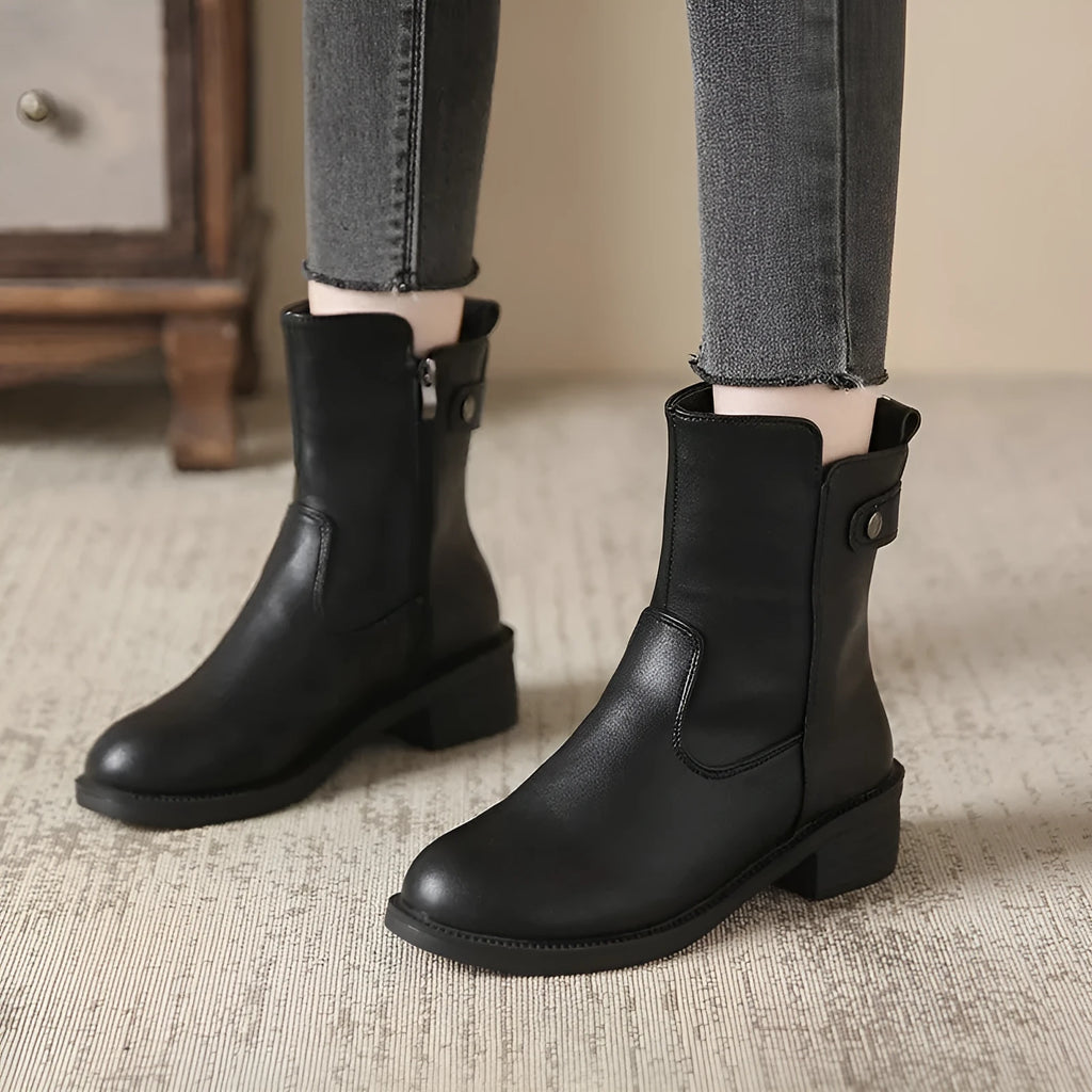 Black women's low heel boots with side zip and round toe on a white background.