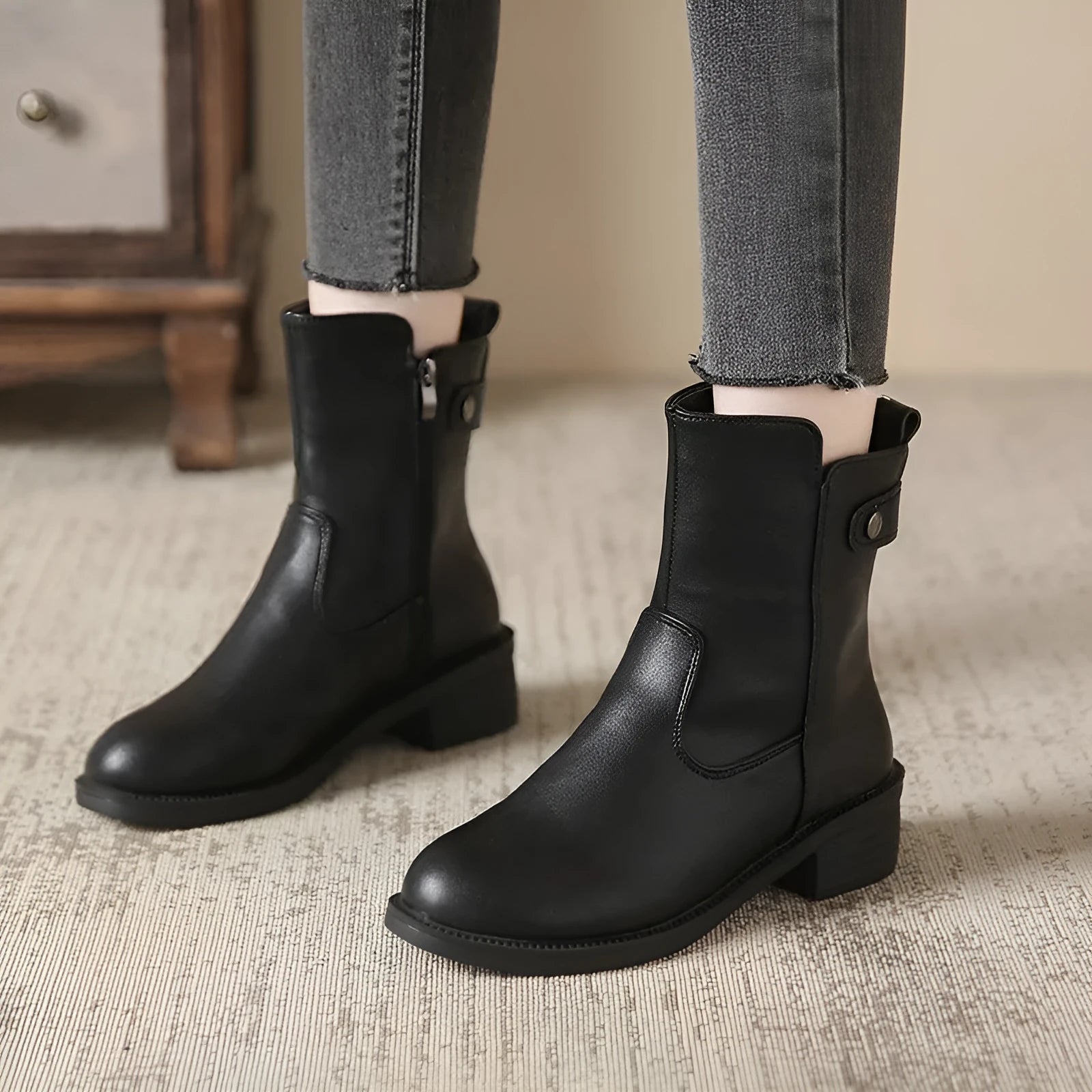 Black women's low heel boots with side zip and round toe on a white background.