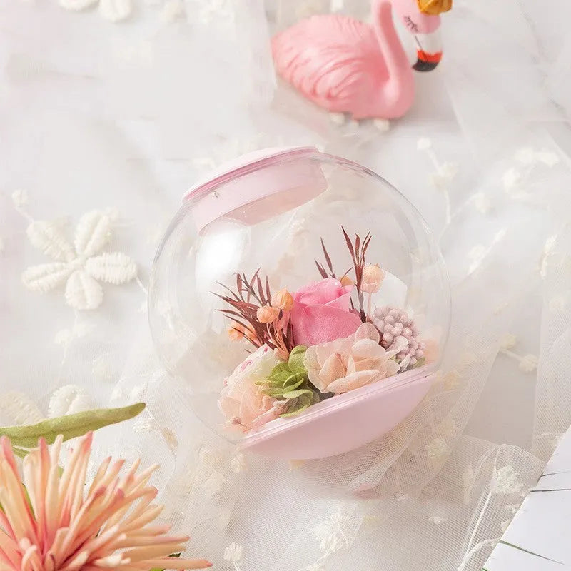 Pink preserved real rose ornament with optional base and Bluetooth audio speaker.