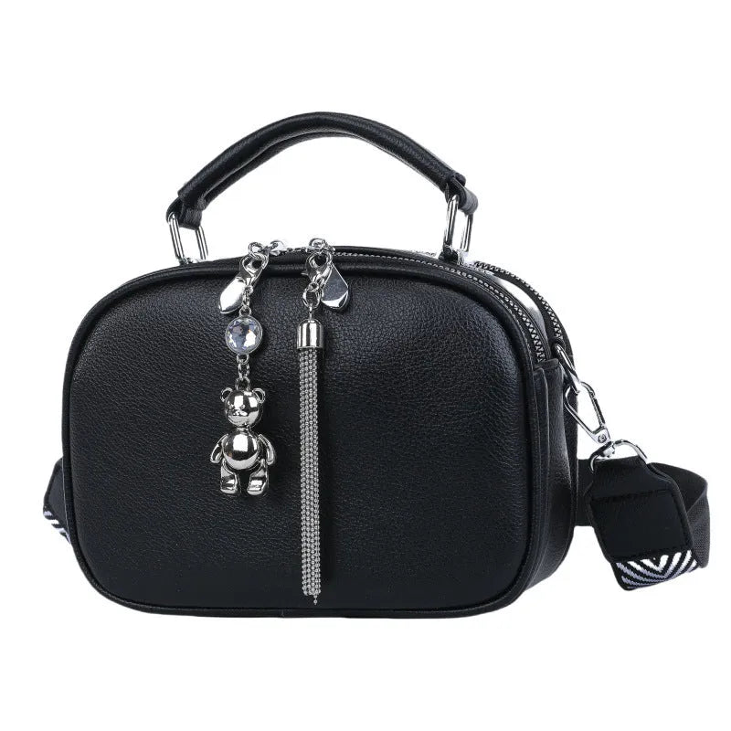 Women's small oval crossbody bag in PU with stitching detail and double straps, shown in multiple colours.
