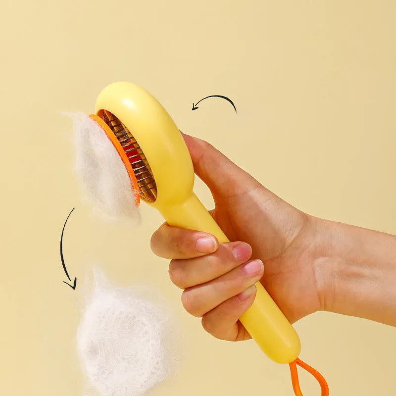 Small yellow duck-shaped pet grooming comb with open needle brush for cats and dogs