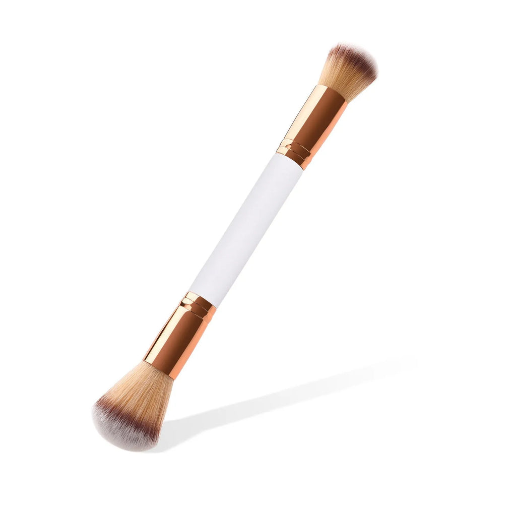 White double head makeup brush with wooden handle and nylon wool bristles on flat surface