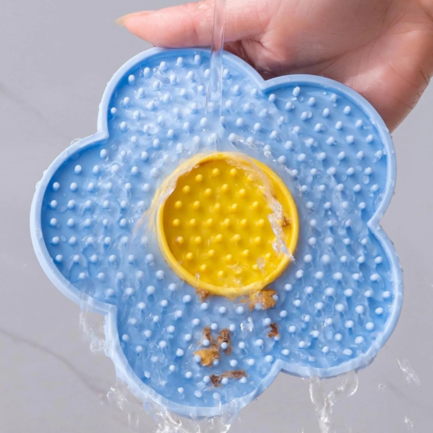 Flower-shaped silicone pet lick mat with suction cups on the base, shown in a choice of colours.