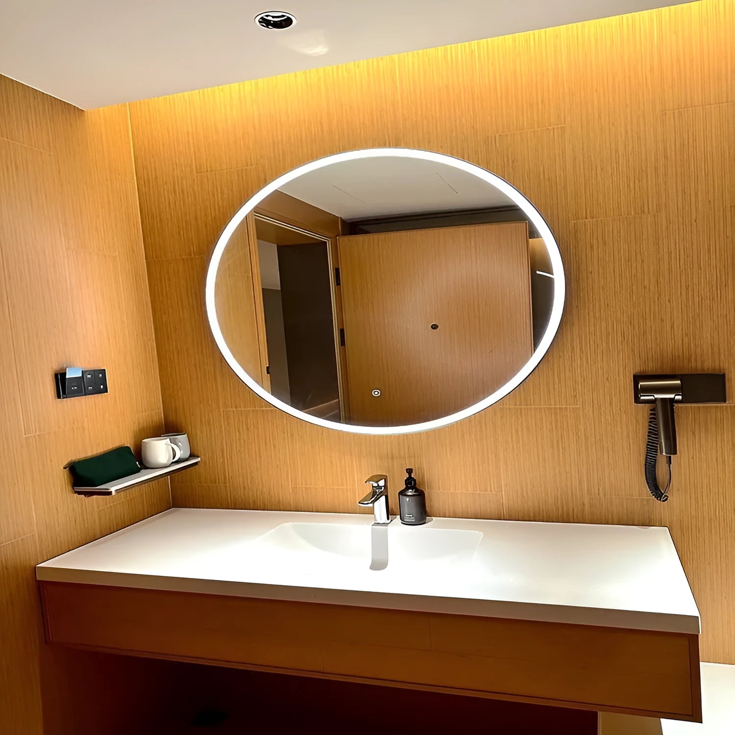 Round black aluminium frame smart bathroom mirror with dimmable LED lights on a wall.