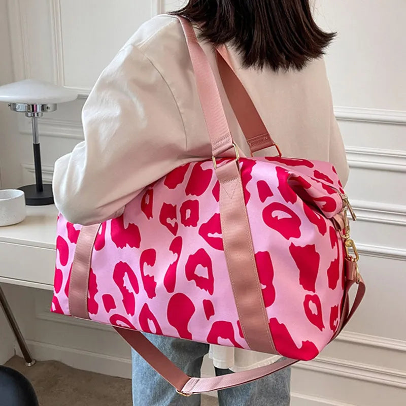 Women's large travel duffel bag with cow pattern, black, showing zippered main compartment and soft handle