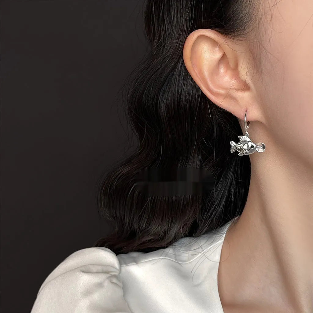 A pair of goldfish-inspired bubble fish design earrings with an electroplated finish on a copper base.