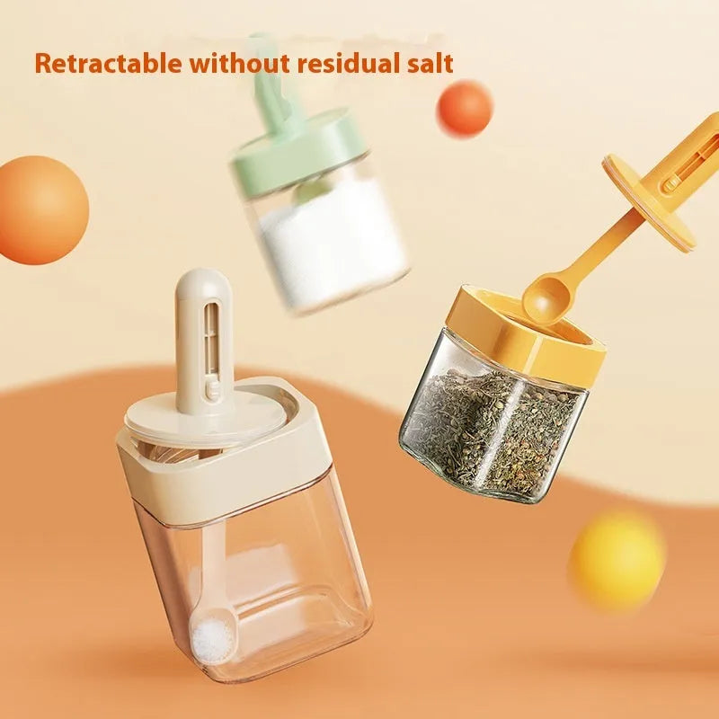 Retractable glass seasoning jar in Nordic style with green lid, showing clear glass body and dispensing mechanism