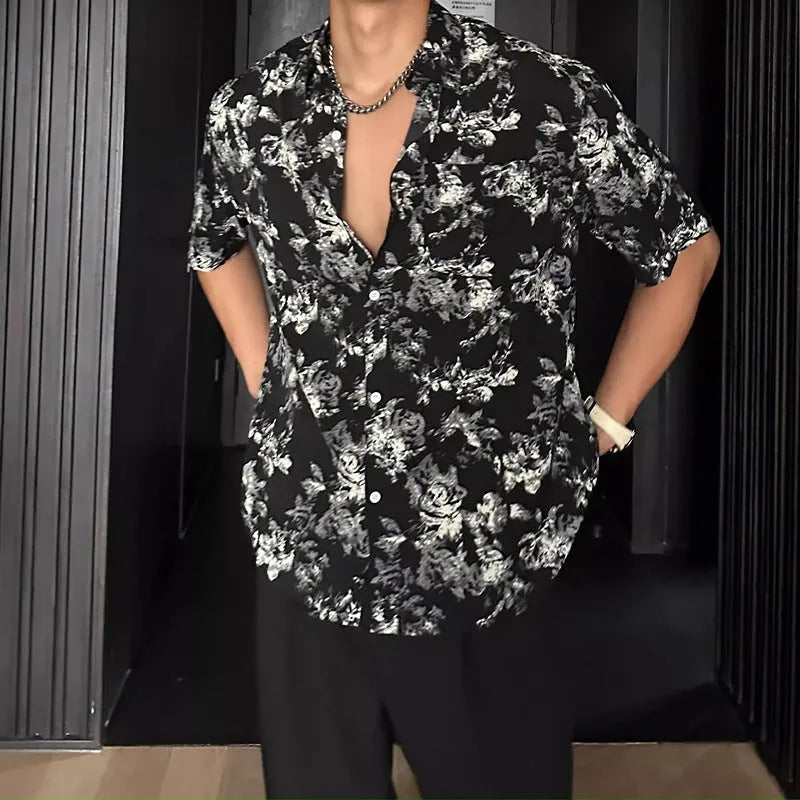 Loose fitting floral printed short sleeve shirt in black on a hanger