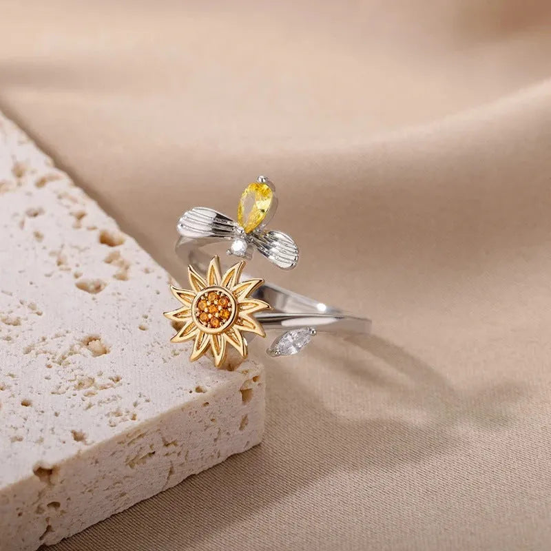 Gold and platinum adjustable geometric decompression spinner rings showing rotatable design