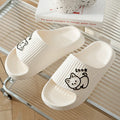 Women's green cat slippers with thick platform sole and flip-flop design on a white background.