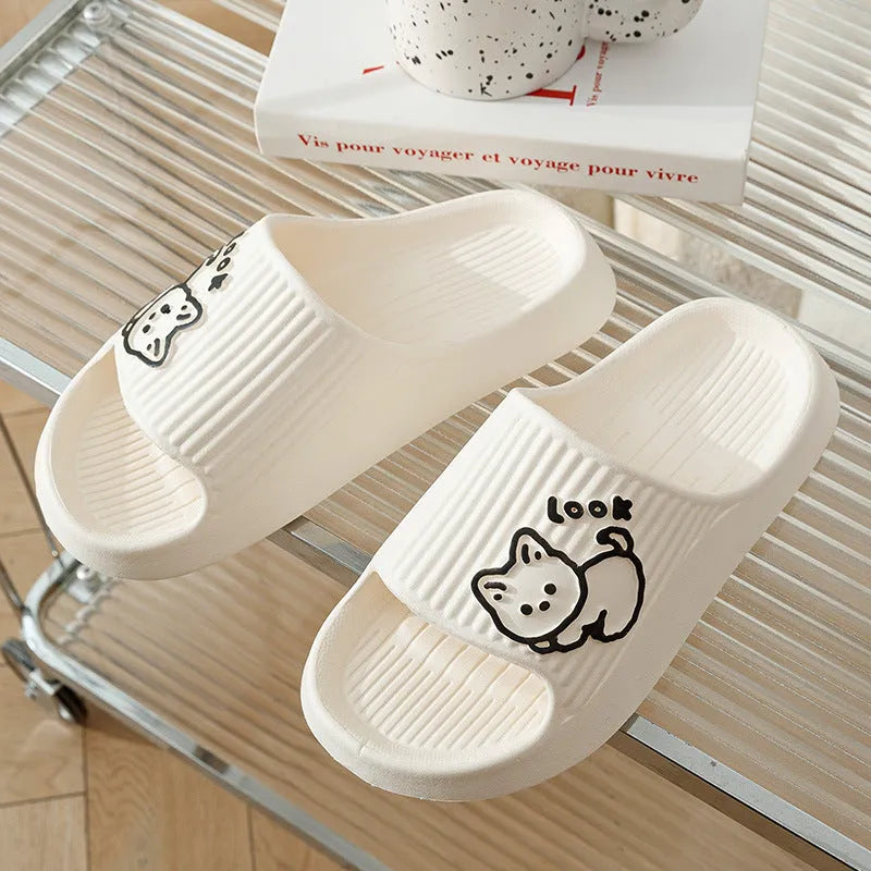 Women's green cat slippers with thick platform sole and flip-flop design on a white background.