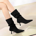 Mid-calf pointed toe stiletto heel boots in dark brown with elastic pleated pile style and sewing line detail.