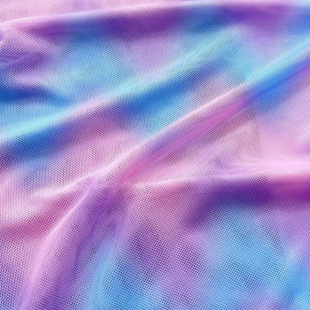 Women's tie-dye pattern bikini set with matching skirt on a neutral background.