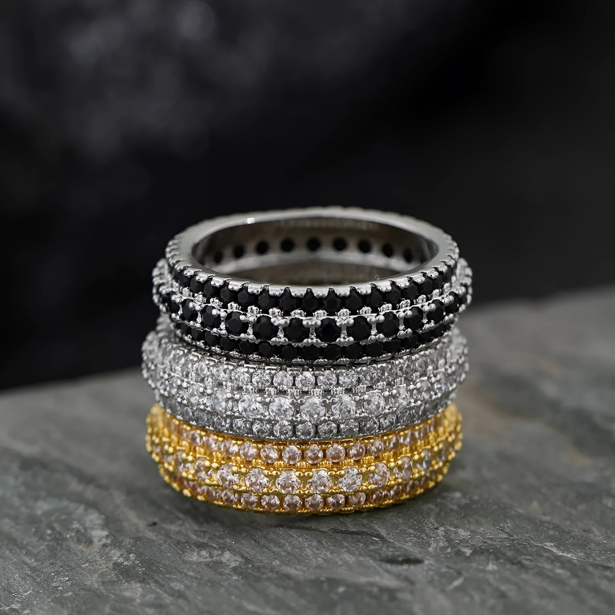 Geometric copper ring with triangular zircon inlay, shown in platinum, yellow gold and white-black finishes.