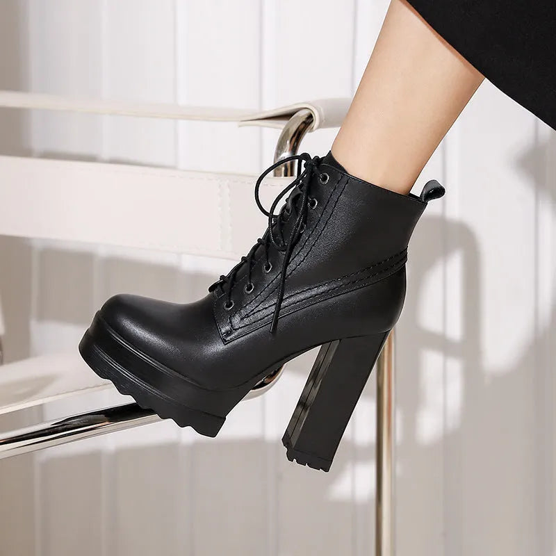 Black women's chunky heel waterproof platform boots with a side zip and round toe.