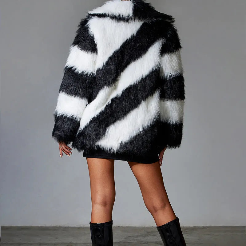 Women's grey faux fur coat with black contrast lapel and a large detachable faux fur collar.
