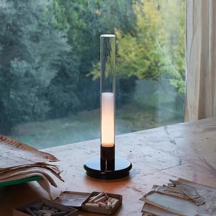 Black Nordic style LED table lamp with three-colour lighting modes on a desk