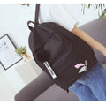 Green canvas college style schoolbag with structured design showing 40cm height and front compartment