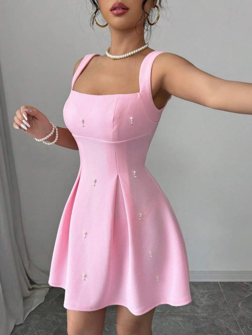 Pink high-waist suspender dress with A-line skirt and sleeveless design, made from polyester.