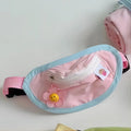 Powder blue messenger-style backpack pet carrier with a poop bag compartment, shown with sizing tape.
