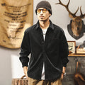 Men's loose-fit long-sleeved corduroy shirt jacket in black or red, showing textured combed cotton fabric.