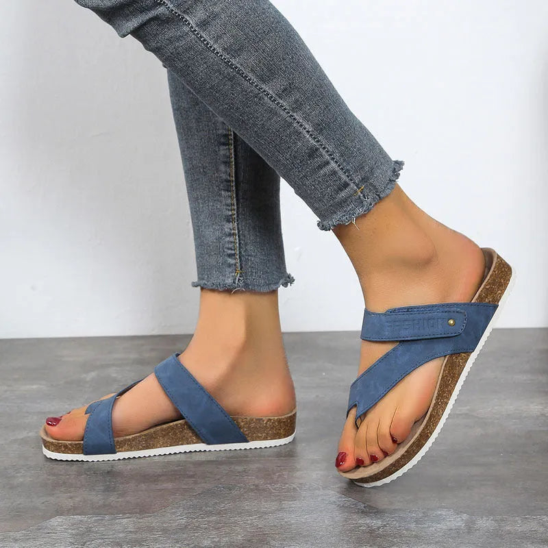 Women's flat toe ring flip-flops in blue with a thick foam sole, shown from the side.