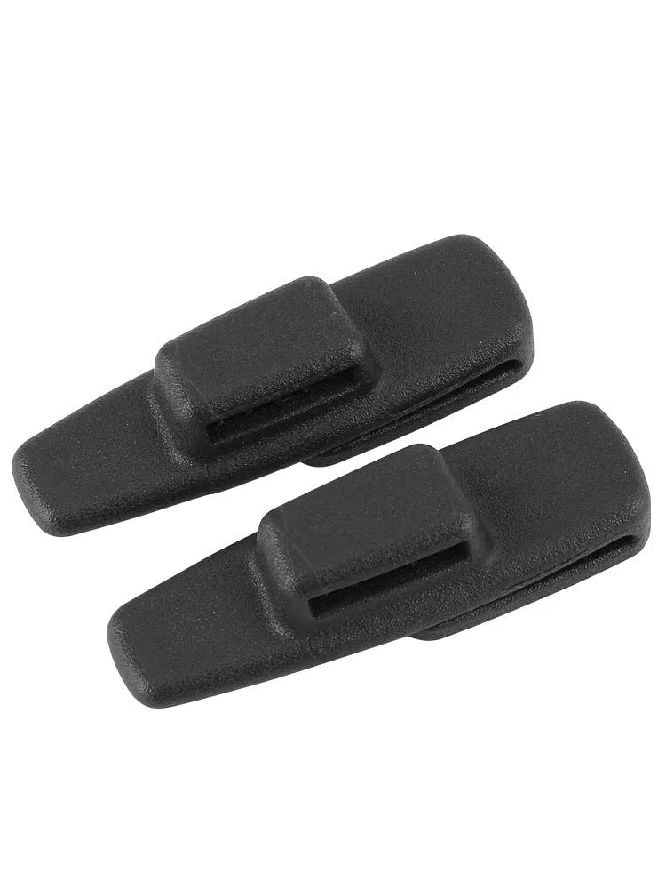 Two black ABS plastic universal seatbelt stopper clips shown next to a car seatbelt.