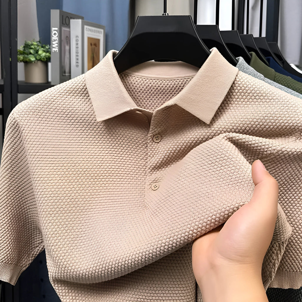 Man wearing a loose fit grey cotton short sleeve sweater, casual pullover style