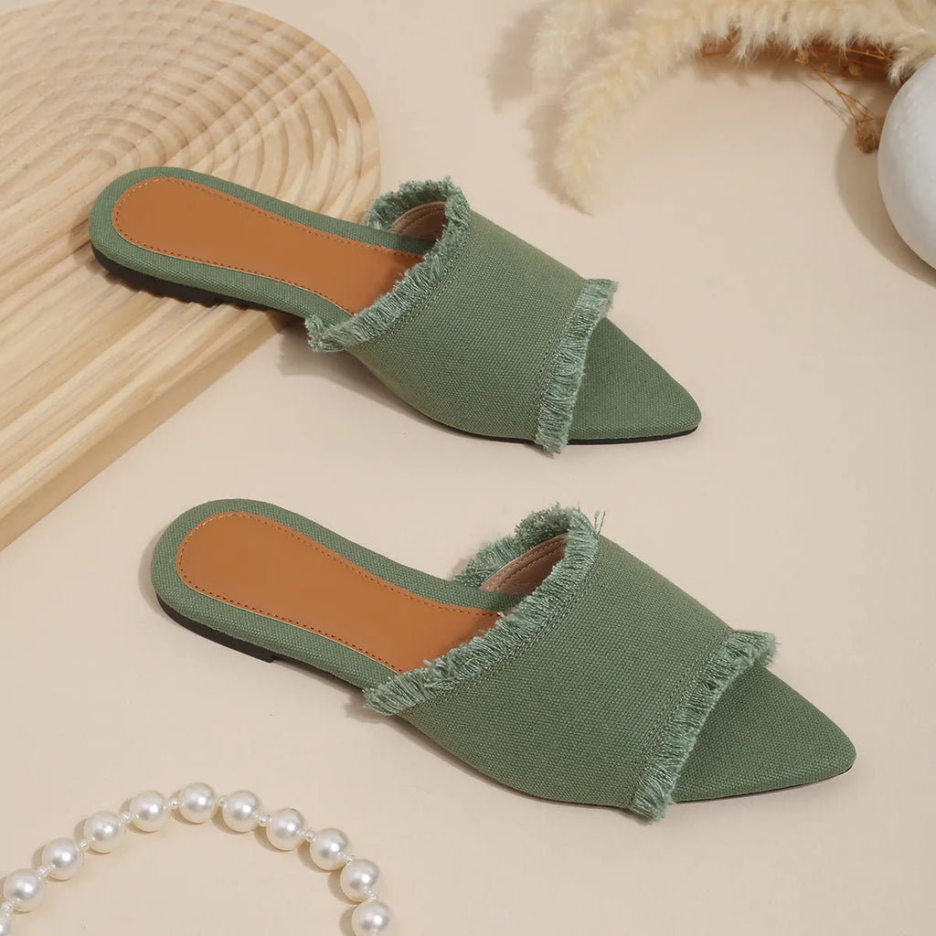 Women's denim flat slipper with tassel detail in apricot colour on a neutral background.