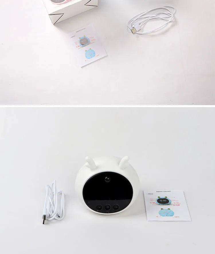 White Deer style smart alarm clock with luminous silicone dial on a bedside table