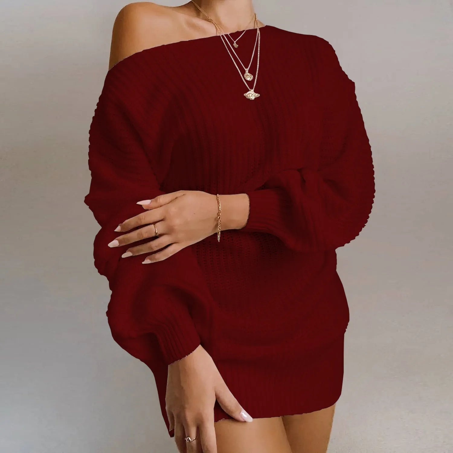 Women's off-the-shoulder knitted dress with full lantern sleeves in a solid colour.